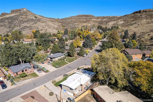 a aerial view of a house with a yard table and chairs