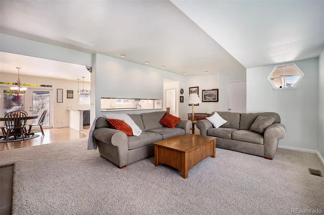 a living room with furniture and white walls
