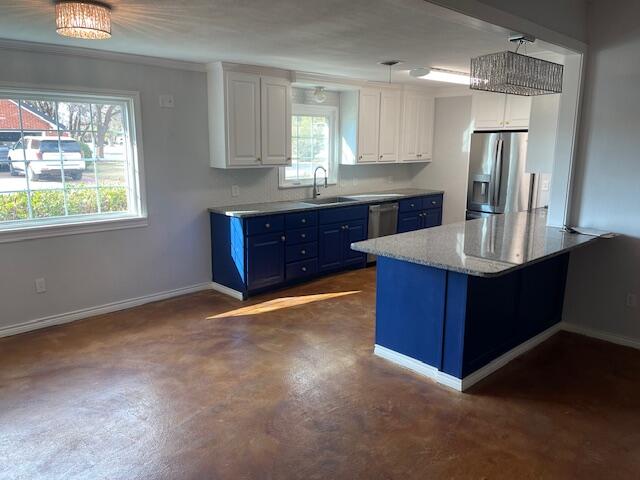 200 East 23rd Street Littlefield, TX 79339 - Photo 7 of 22 a kitchen with kitchen island granite countertop a stove refrigerator and microwave