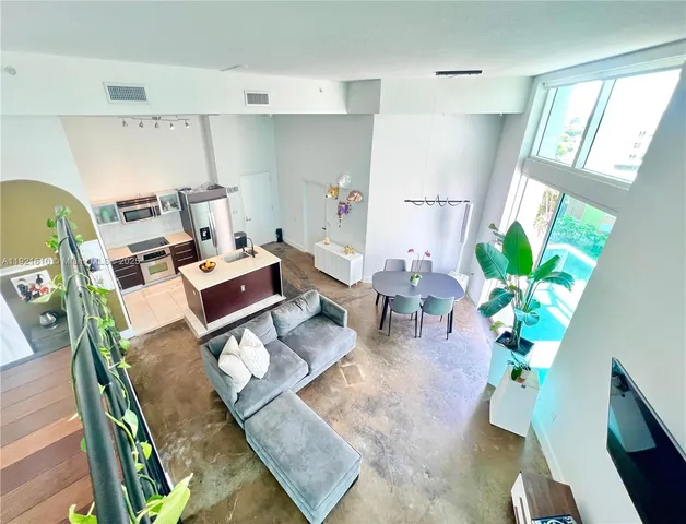 a bedroom with a bed a couch and dresser