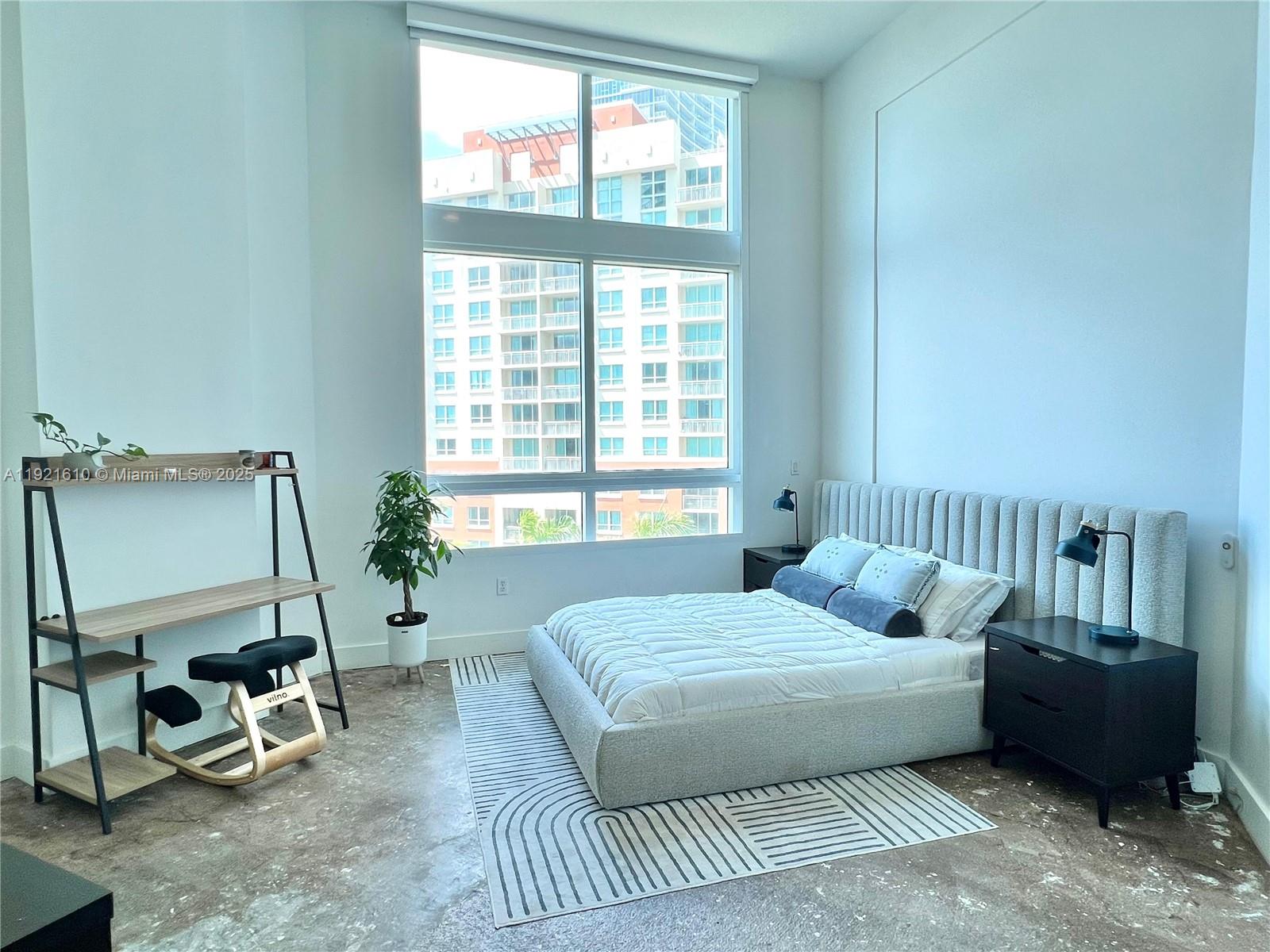 1900 North Bayshore Drive, Unit 909 Miami, FL 33132 - Photo 13 of 23 a bedroom with a bed a couch and dresser