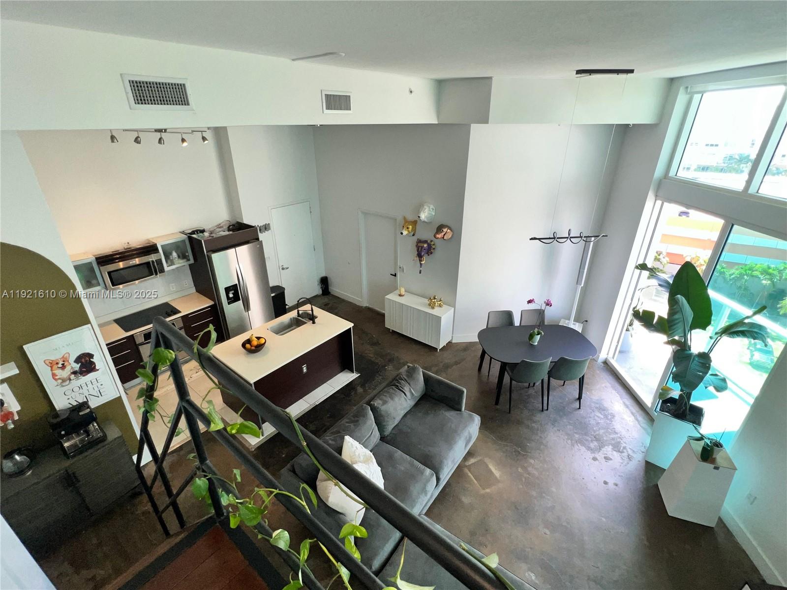 1900 North Bayshore Drive, Unit 909 Miami, FL 33132 - Photo 19 of 23 a living room with furniture and a wooden floor