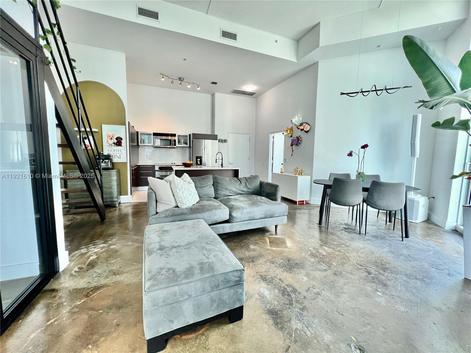 1900 North Bayshore Drive, Unit 909 Miami, FL 33132 - Photo 3 of 23 a living room with furniture and a large window