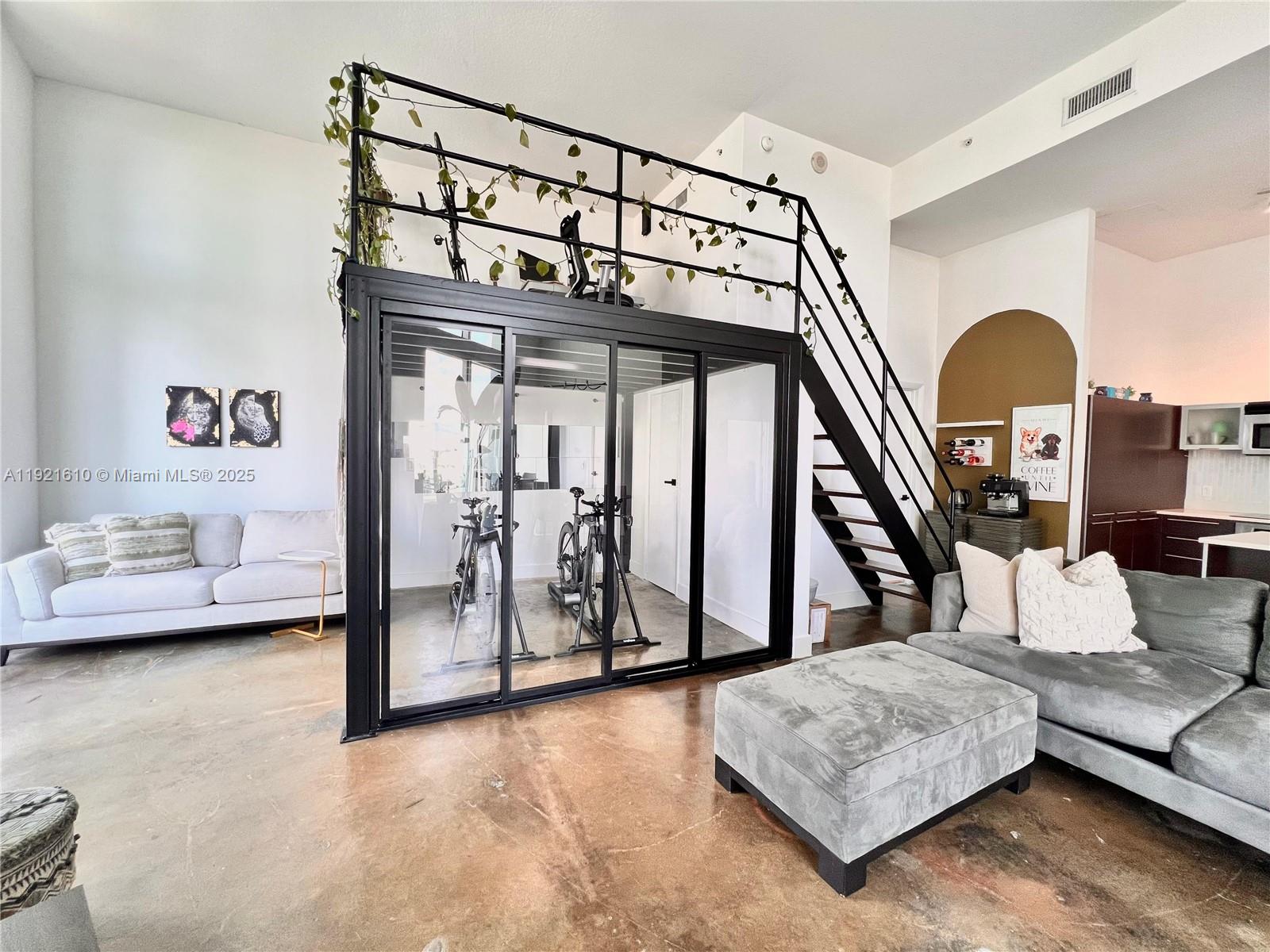 1900 North Bayshore Drive, Unit 909 Miami, FL 33132 - Photo 5 of 23 a living room with furniture and a baby crib