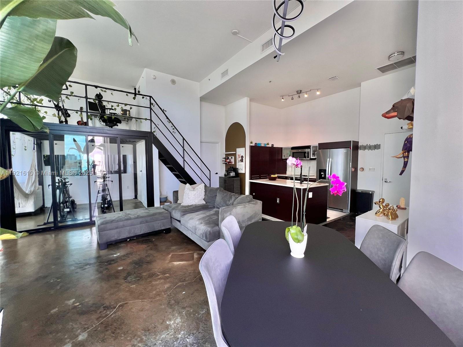 1900 North Bayshore Drive, Unit 909 Miami, FL 33132 - Photo 7 of 23 a living room with lots of furniture and a chandelier