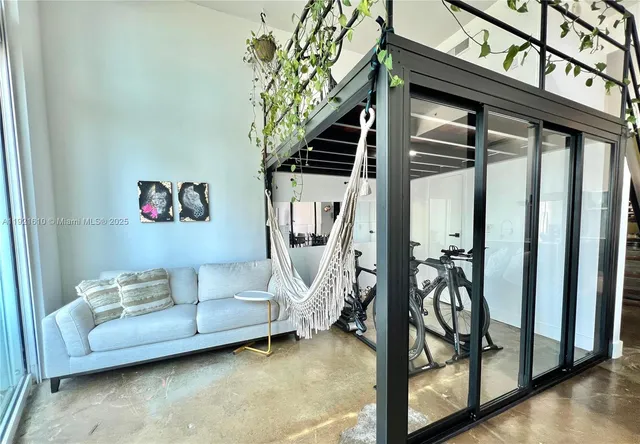 a view of a staircase with furniture and lots of frames on wall