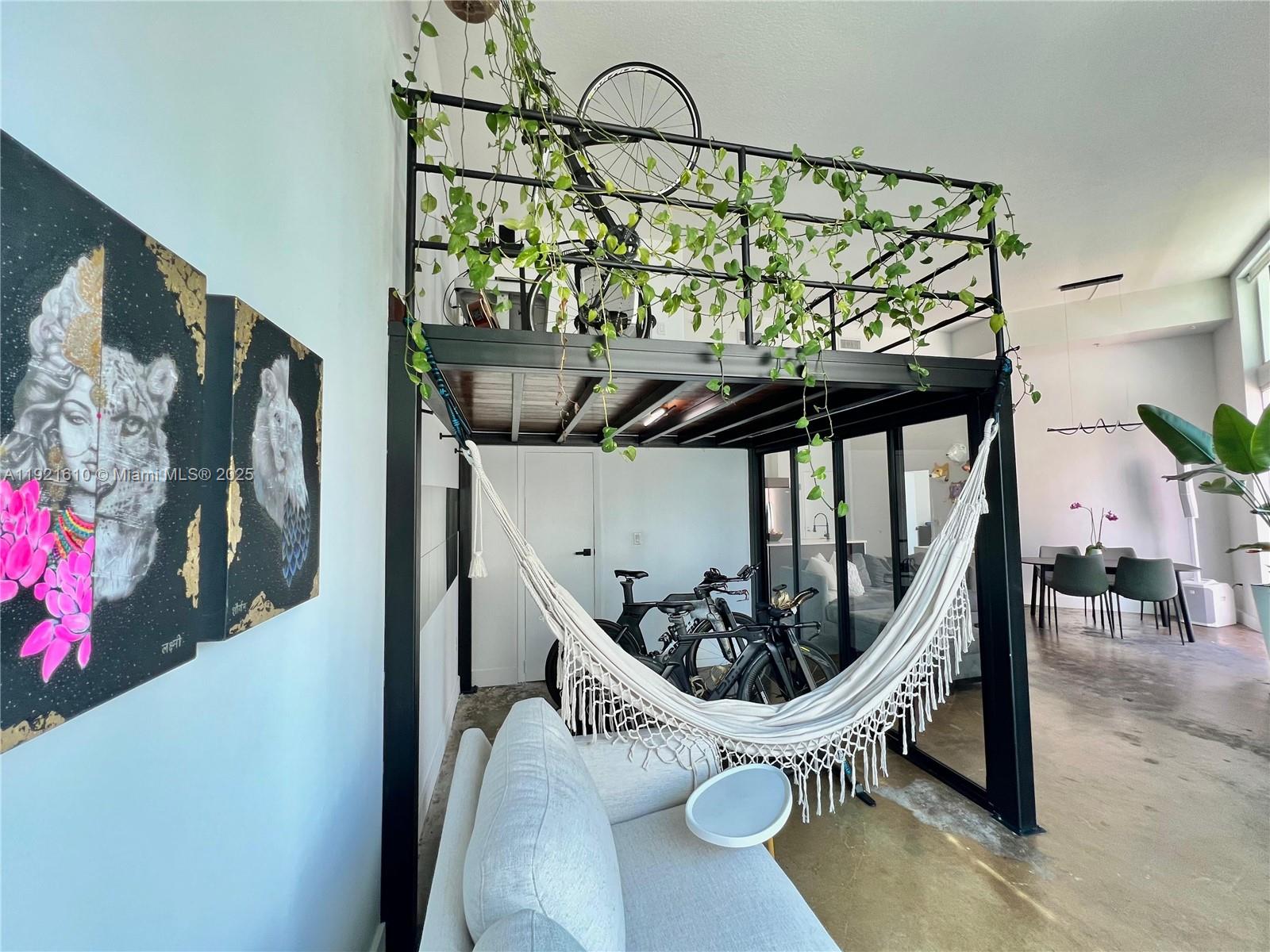 1900 North Bayshore Drive, Unit 909 Miami, FL 33132 - Photo 9 of 23 a view of a staircase with furniture and lots of frames on wall