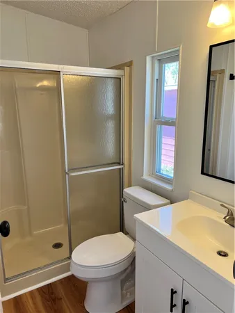 a bathroom with a sink toilet and shower
