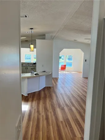 a view of an empty room and wooden floor