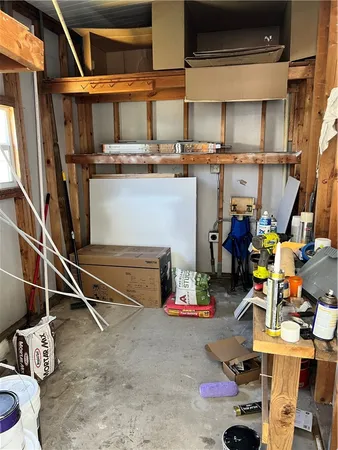 a storage room with lots of clutter and chairs