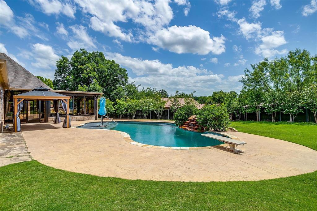 a view of a house with swimming pool and a yard