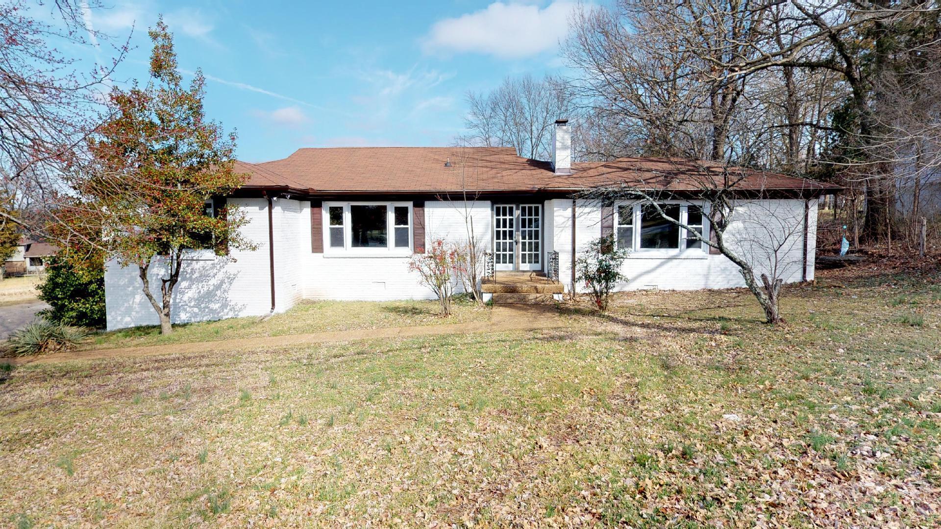 3064 Anderson Road Nashville, TN 37217 - Photo 1 of 29 a backyard of a house with table and chairs