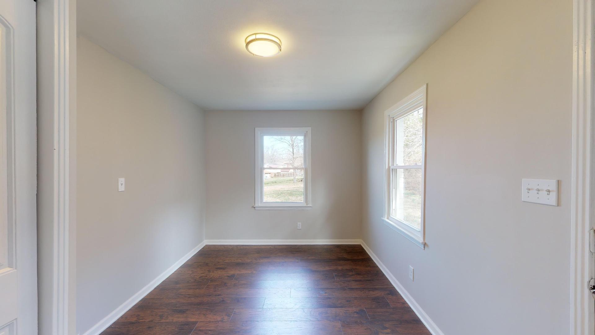 3064 Anderson Road Nashville, TN 37217 - Photo 16 of 29 an empty room with wooden floor and windows
