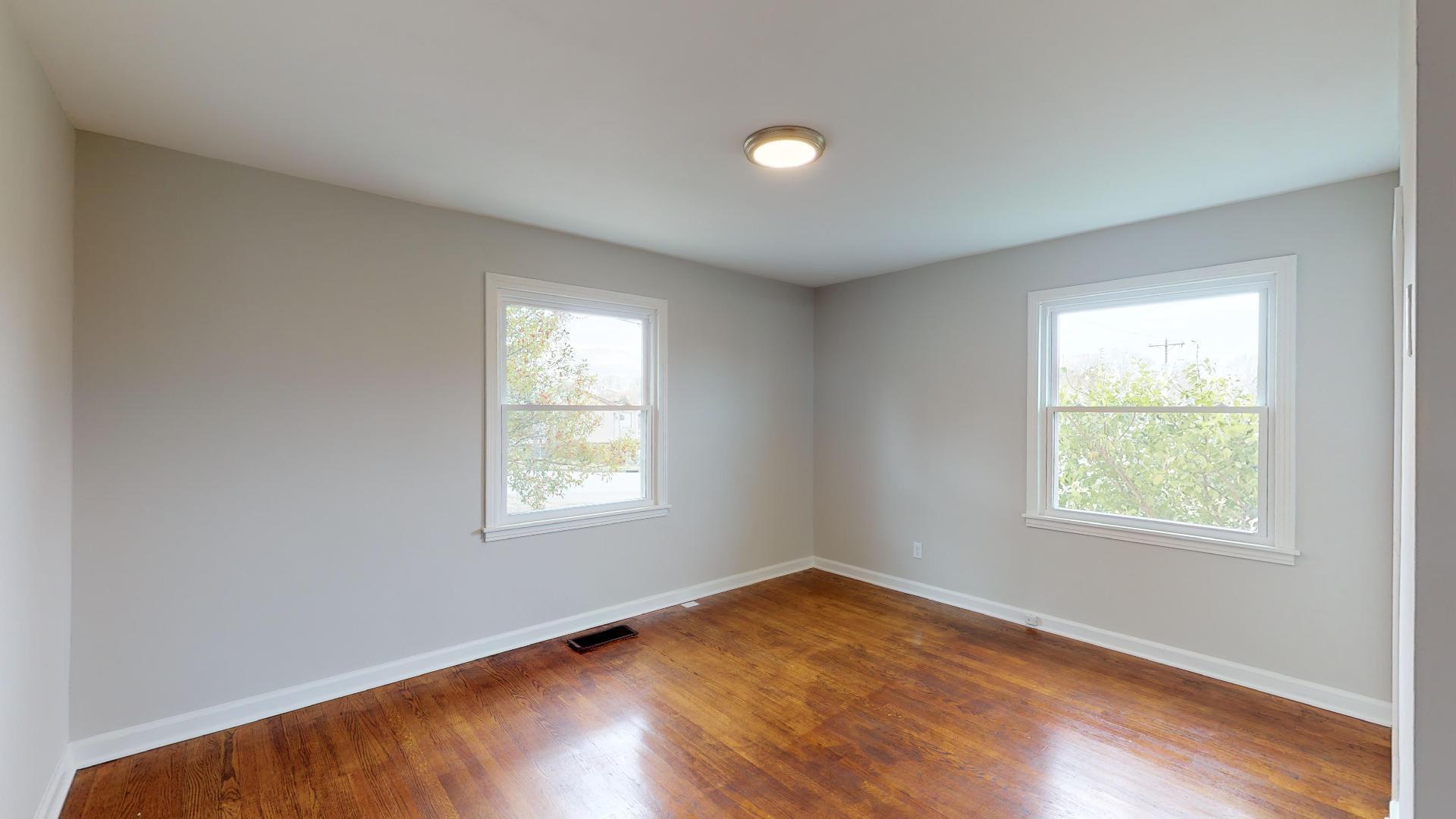 3064 Anderson Road Nashville, TN 37217 - Photo 18 of 29 an empty room with wooden floor and windows