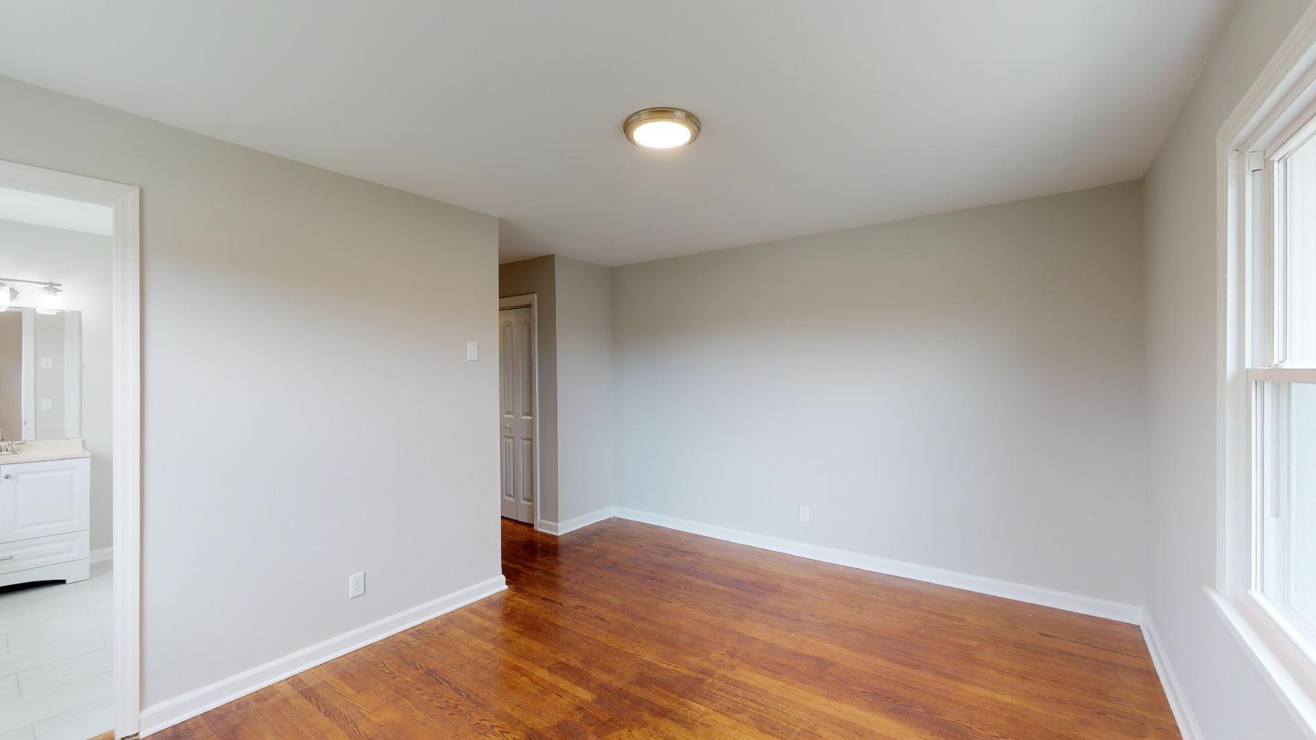 3064 Anderson Road Nashville, TN 37217 - Photo 19 of 29 an empty room with wooden floor and windows