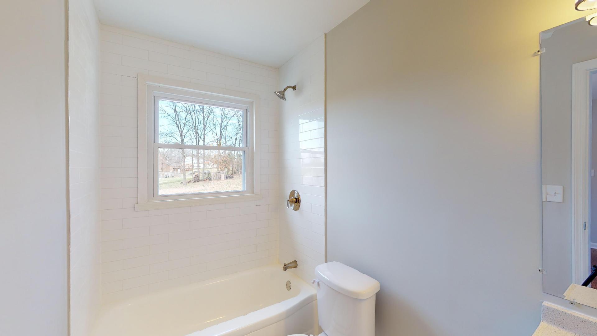 3064 Anderson Road Nashville, TN 37217 - Photo 24 of 29 a white bath tub sitting next to a white toilet