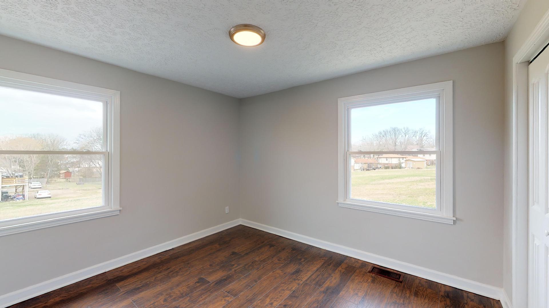 3064 Anderson Road Nashville, TN 37217 - Photo 25 of 29 a view of an empty room with wooden floor and a window