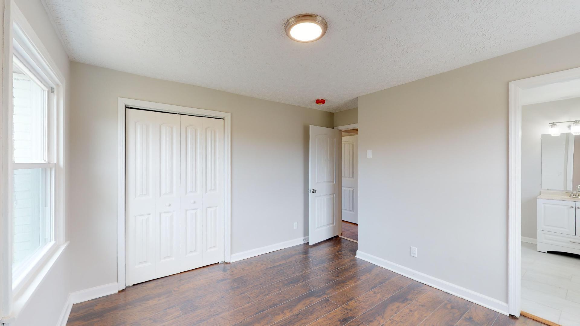 3064 Anderson Road Nashville, TN 37217 - Photo 26 of 29 an empty room with wooden floor and windows