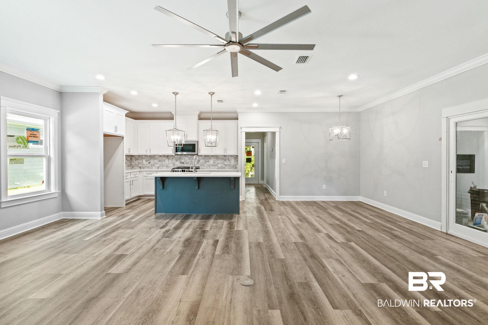 12441 Reunion Place Foley, AL 36535 - Photo 6 of 31 Kitchen featuring tasteful backsplash, pendant lighting, light hardwood / wood-style floors, and a kitchen island with sink