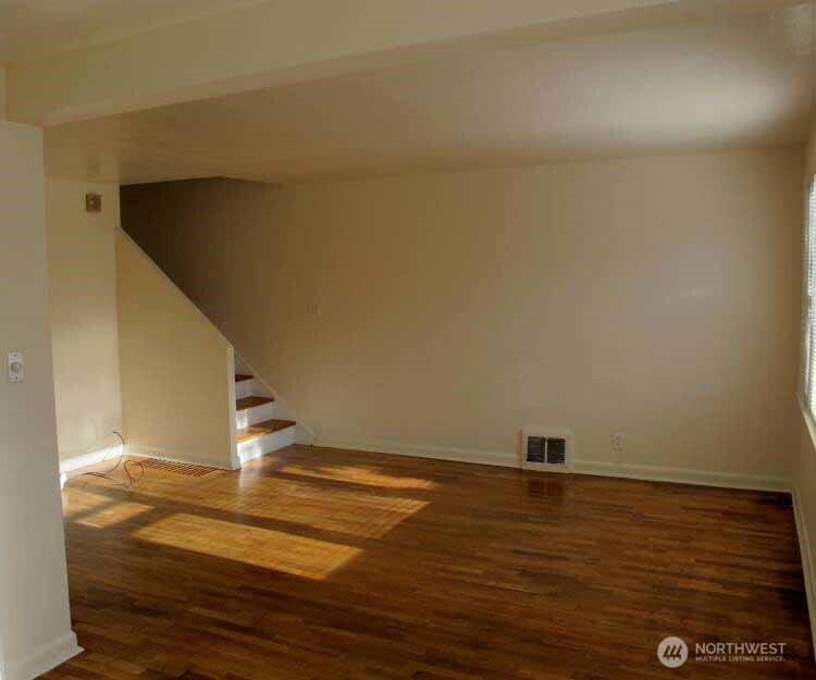 8001 Densmore Avenue North Seattle, WA 98103 - Photo 12 of 22 a view of empty room with wooden floor