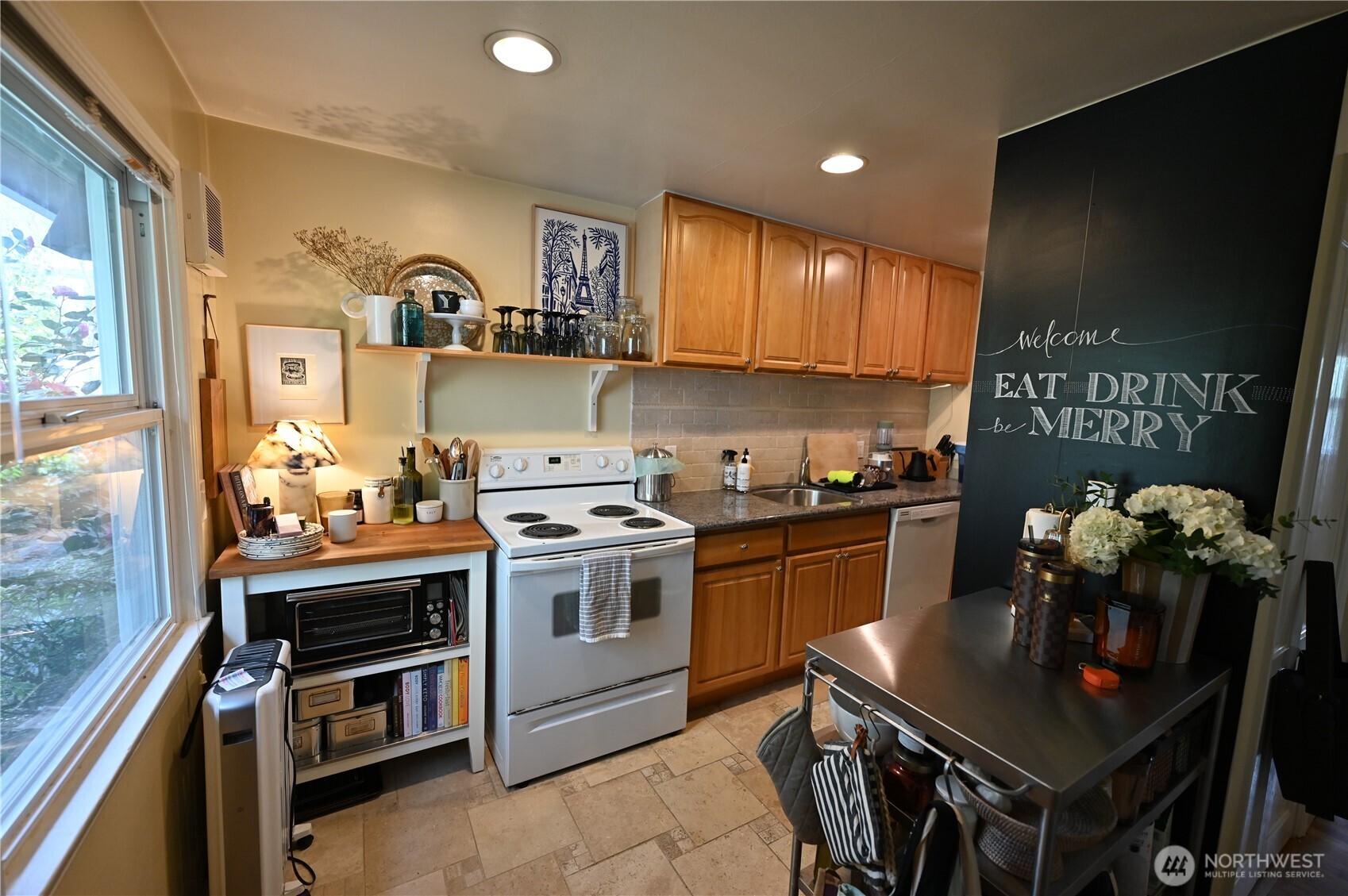 8001 Densmore Avenue North Seattle, WA 98103 - Photo 13 of 22 a kitchen with a stove and a refrigerator