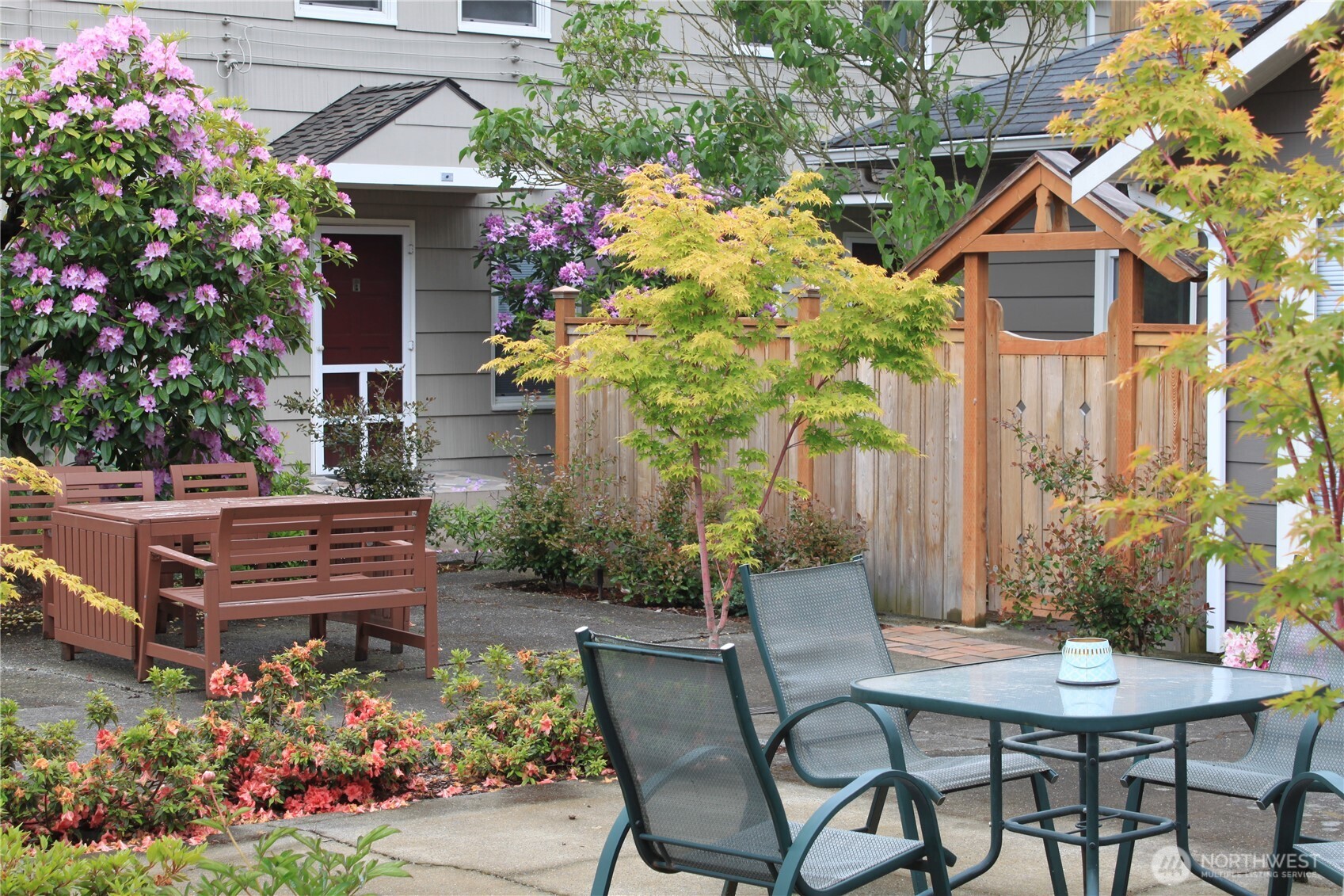 8001 Densmore Avenue North Seattle, WA 98103 - Photo 20 of 22 a table and chairs in front of a house