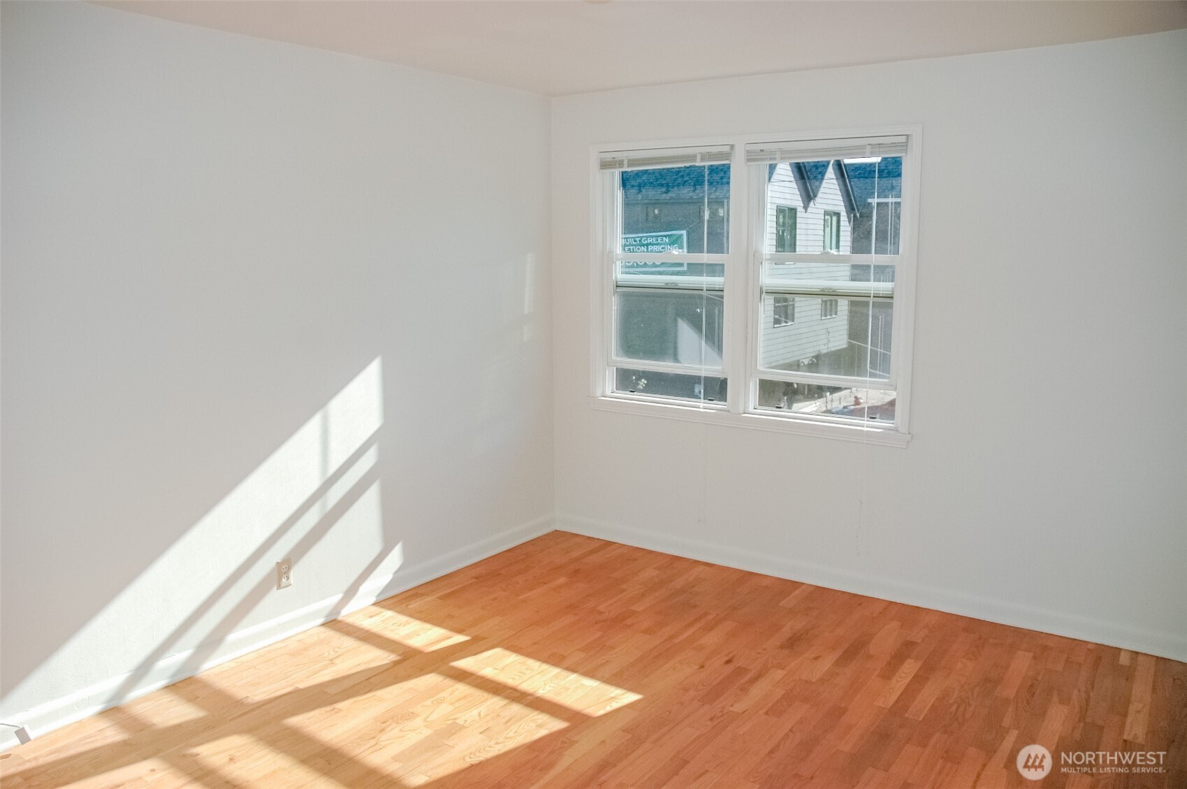 8001 Densmore Avenue North Seattle, WA 98103 - Photo 7 of 22 a view of a room with wooden floor and a window