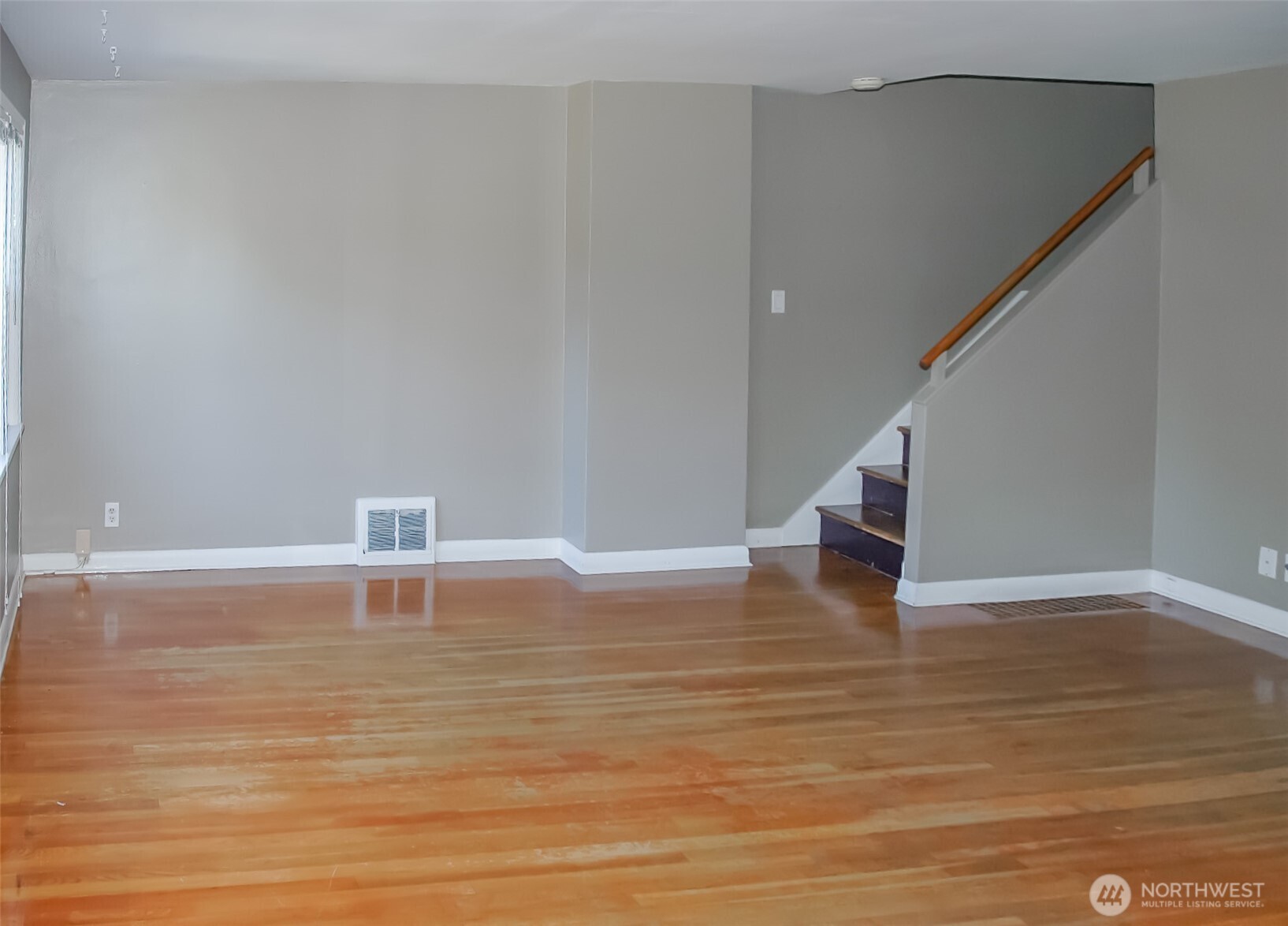 8001 Densmore Avenue North Seattle, WA 98103 - Photo 9 of 22 a view of empty room with wooden floor