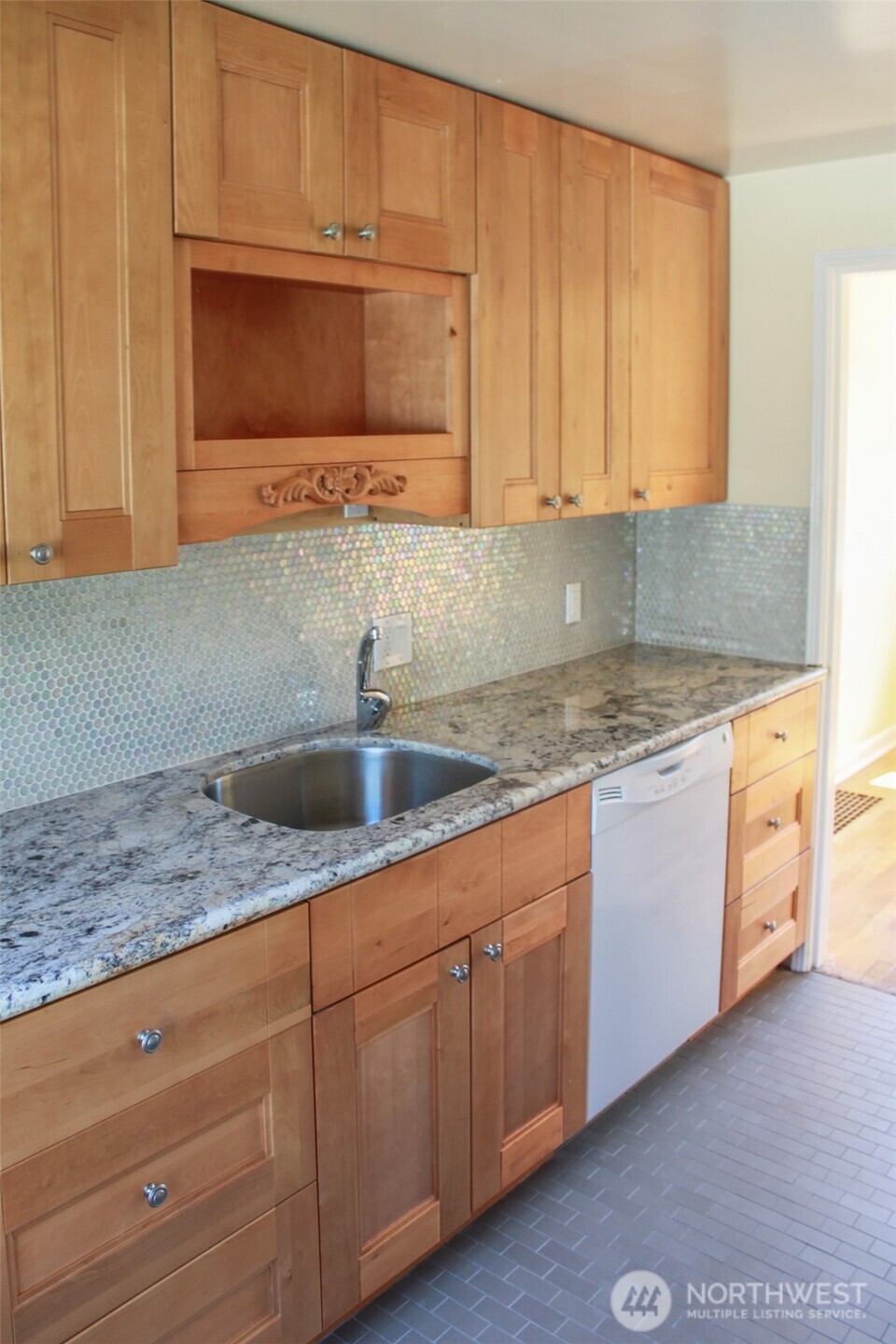 8001 Densmore Avenue North Seattle, WA 98103 - Photo 10 of 22 a kitchen with granite countertop cabinets stainless steel appliances and sink