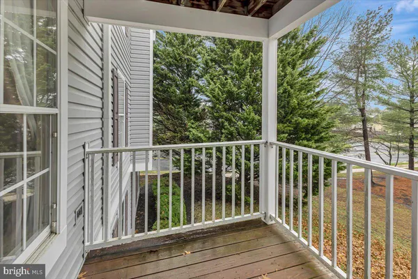 a view of a balcony with wooden floor