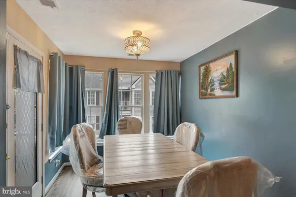 a view of a dining room with furniture wooden floor and chandelier