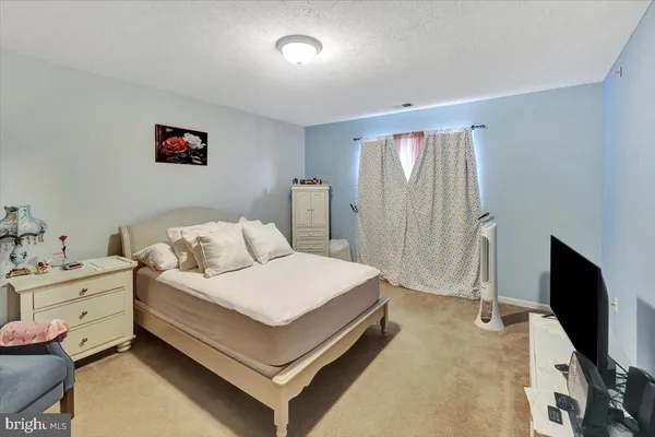 a room with a bed and a flat screen tv
