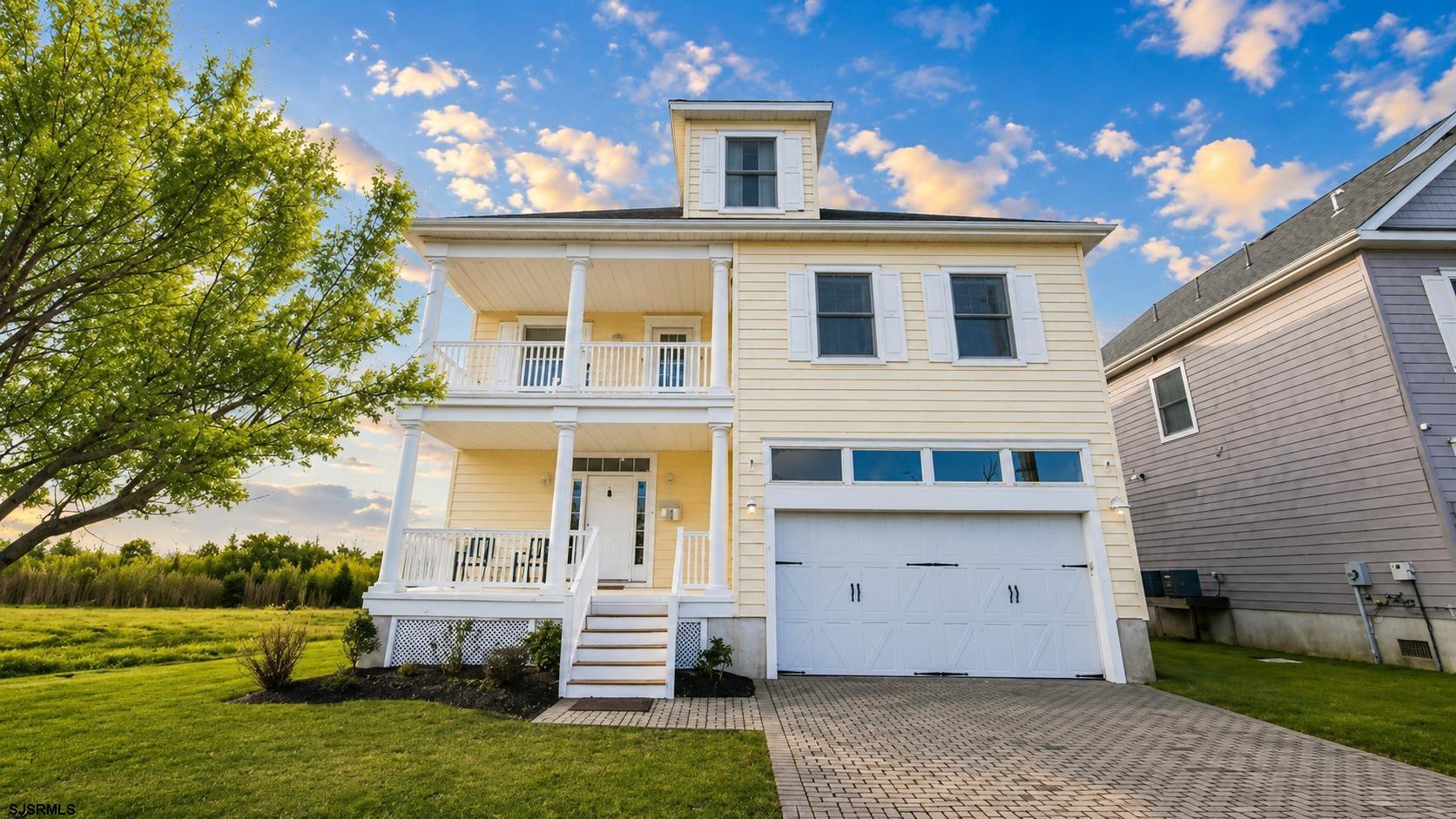 2070 West Riverside Drive Atlantic City, NJ 08401 - Photo 1 of 40 a front view of a house with a yard
