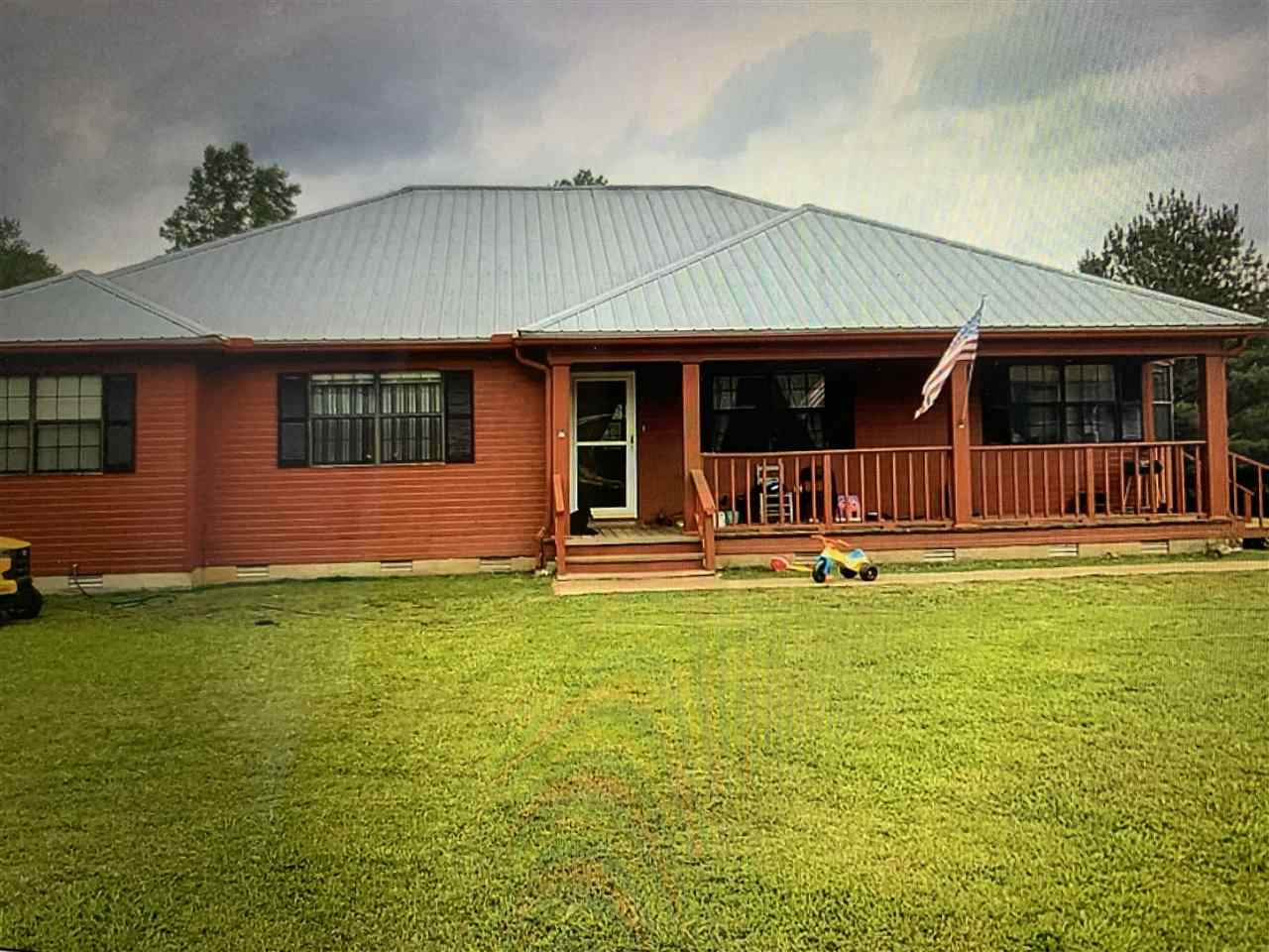 1130 Britt Road Beech Bluff, TN 38313 - Photo 1 of 1 a front view of a house with swimming pool having outdoor seating