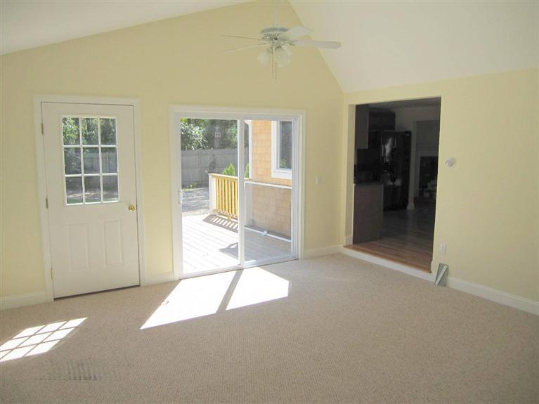 560 Skunknet Road Centerville, MA 02632 - Photo 11 of 24 an empty room with windows and entrance