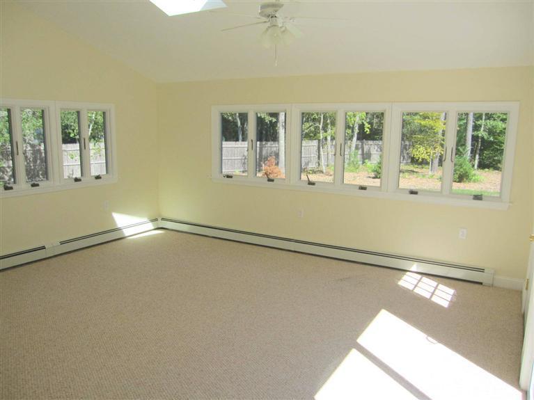 560 Skunknet Road Centerville, MA 02632 - Photo 12 of 24 a view of a living room with a large window