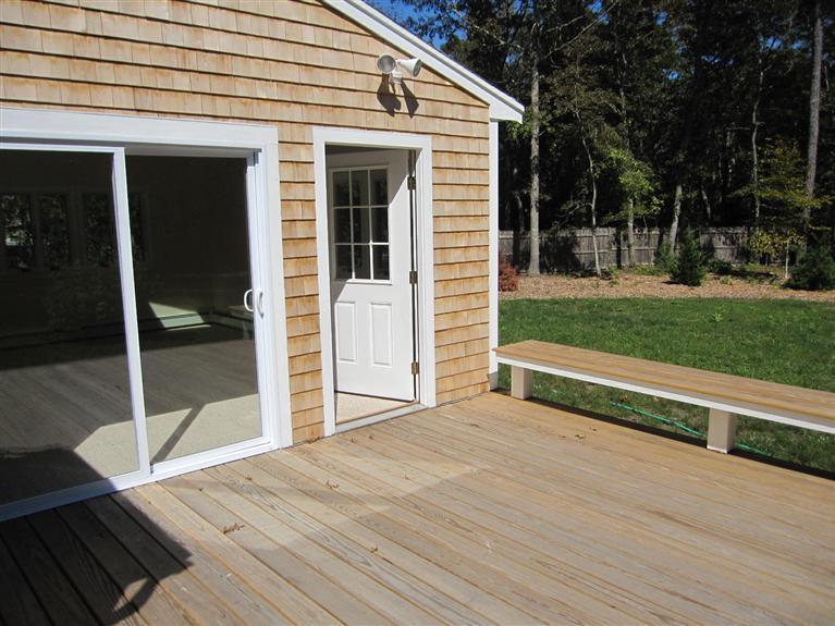 560 Skunknet Road Centerville, MA 02632 - Photo 14 of 24 a view of backyard with wooden deck and backyard