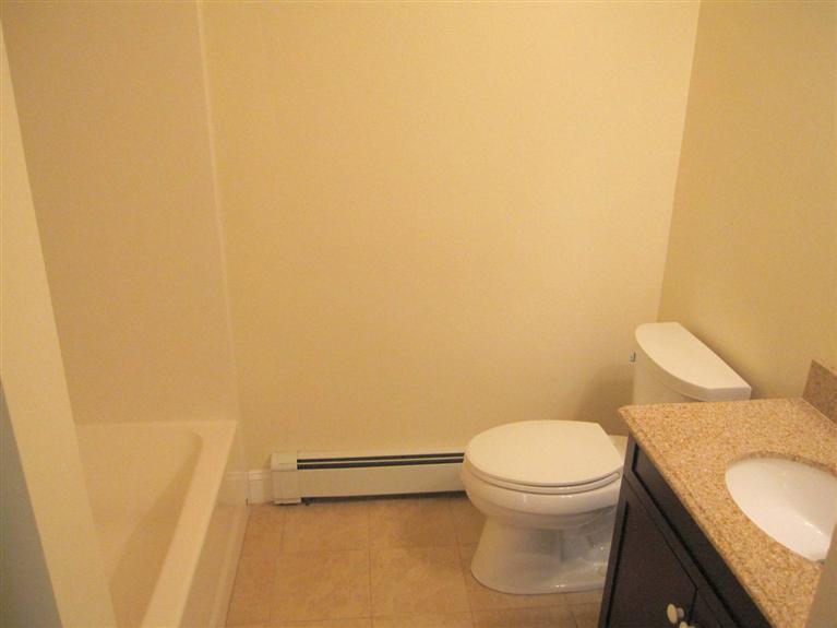 560 Skunknet Road Centerville, MA 02632 - Photo 17 of 24 a bathroom with a granite countertop toilet and a sink