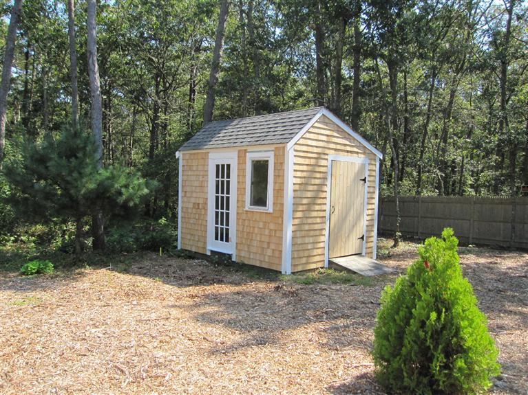 560 Skunknet Road Centerville, MA 02632 - Photo 24 of 24 a view of a house with a yard and large trees