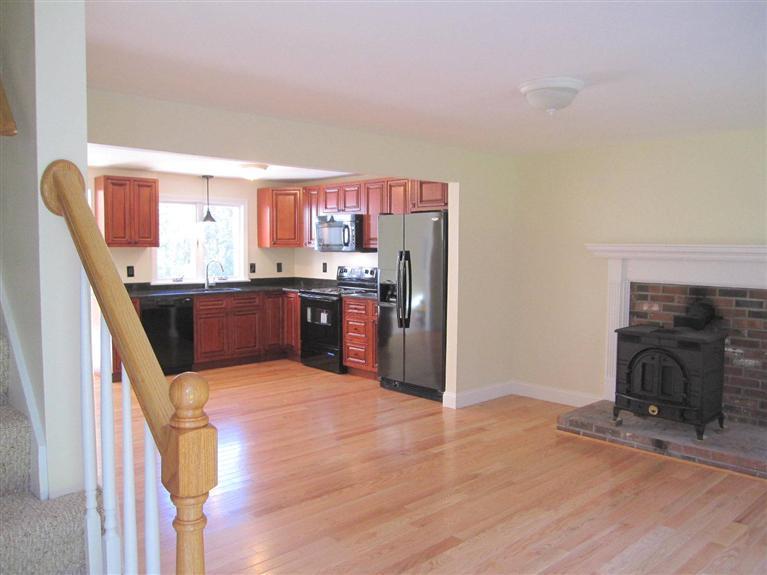 560 Skunknet Road Centerville, MA 02632 - Photo 7 of 24 a kitchen with stainless steel appliances granite countertop a stove and a refrigerator