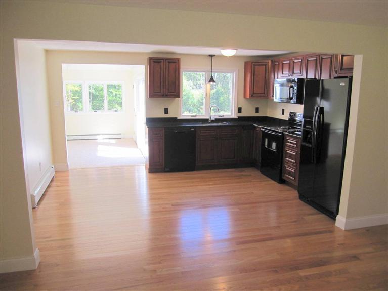 560 Skunknet Road Centerville, MA 02632 - Photo 8 of 24 a kitchen with granite countertop a refrigerator and a stove top oven