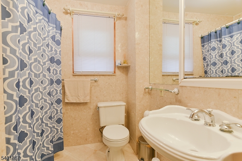 72 Rector Street Millburn, NJ 07041 - Photo 12 of 14 a bathroom with a sink and a mirror