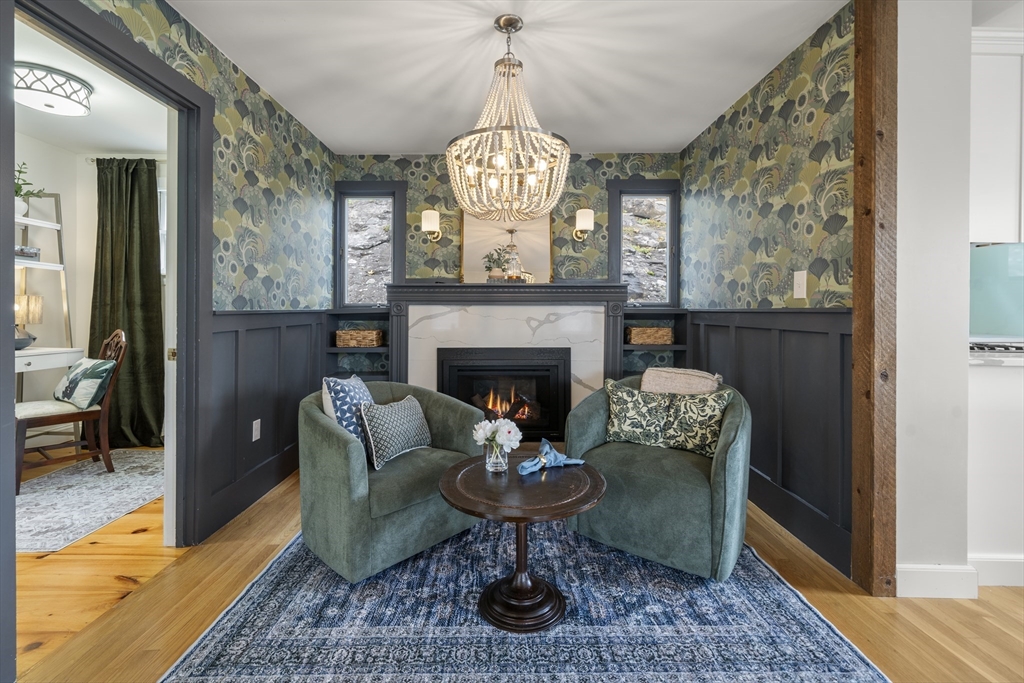 11 Gingerbread Hill Marblehead, MA 01945 - Photo 12 of 20 a living room with furniture a chandelier and a fireplace