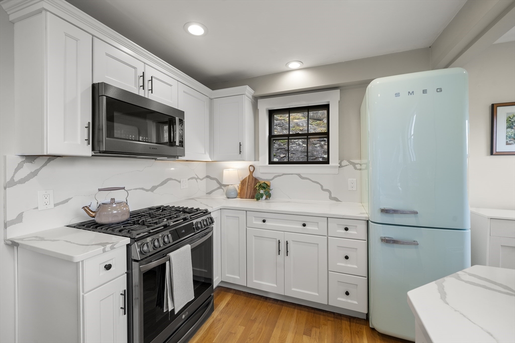 11 Gingerbread Hill Marblehead, MA 01945 - Photo 10 of 20 a kitchen with granite countertop cabinets stainless steel appliances and wooden floor