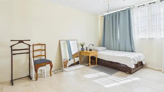 a bedroom with a bed and a table in it