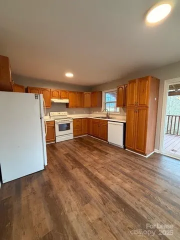 a kitchen with a stove top oven and refrigerator