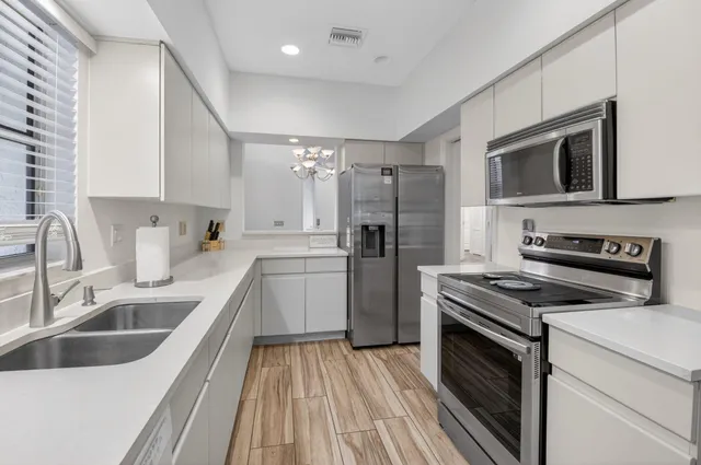 a kitchen with a sink stove and refrigerator
