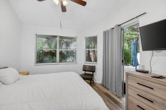 a bedroom with a bed and a flat tv screen