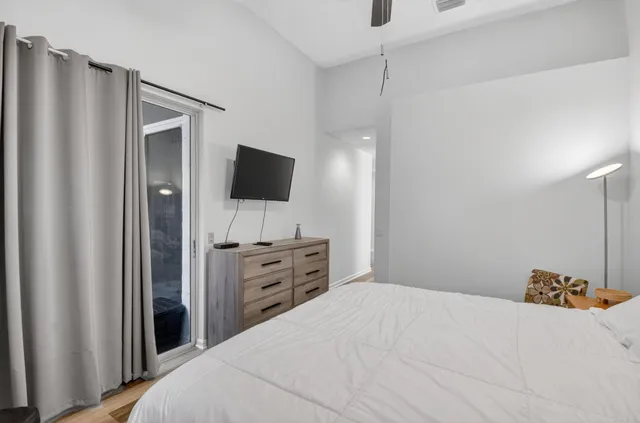 a bedroom with a bed and a flat screen tv