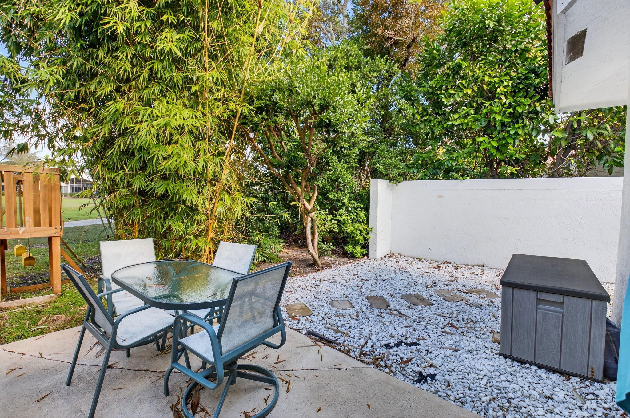 2225 Northwest 53rd Street Boca Raton, FL 33496 - Photo 28 of 46 a patio with table and chairs and potted plants